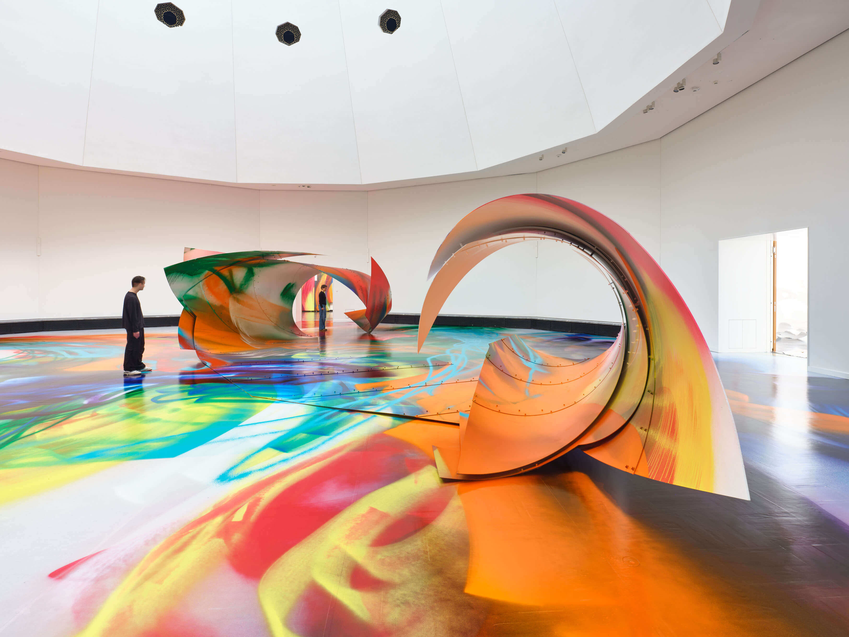 Katharina Grosse installation covered in bright sprayed paint across walls and objects